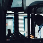 silhouette photography of man driving bus