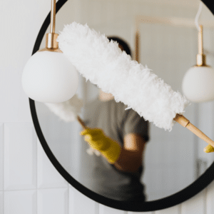 Image of a feather duster cleaning a light fitting